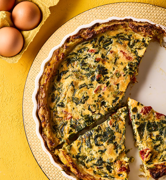 Potato-crusted quiche filled with spinach and sun-dried tomatoes