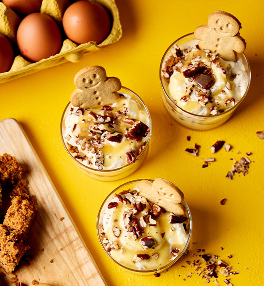 Festive gingerbread trifle where the mini gingerbread men look like they're sitting in trifle hot tubs