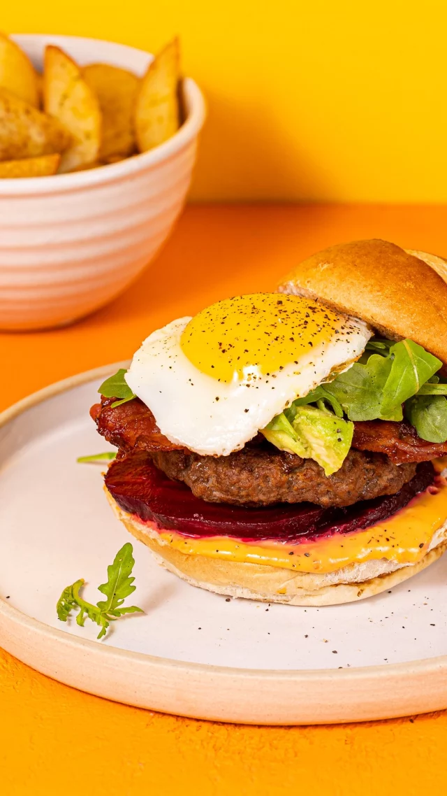Sun’s out, time to fire up the barbie! ☀️🔥
With the British weather set to be GORGEOUS for the next few weeks, many a BBQ will be dusted off and shop shelves raided for burgers, baps and picky bits galore.

So if you fancy dinner in the sunshine in less than 30 mins, try switching up your standard burgers with this Aussie eggy twist:

500g good-quality minced beef
4 tablespoons red onion marmalade
8 slices smoked pancetta or streaky bacon
4 burger buns
Vegetable oil
Sea salt and freshly ground black pepper
4 FREE eggs
4 tablespoons free range egg mayonnaise or your favourite burger sauce
2 beetroots in juice, sliced
1 avocado, de-stoned, peeled and sliced
2 handfuls of rocket leaves

How to make:

Line a plate with greaseproof paper.

Mix minced beef and red onion marmalade together in a bowl, then divide into four, shaping into patties. Put the patties on the lined plate, cover with cling film and chilling the fridge.

Fry the pancetta or bacon in a large frying pan until crisp then put to one side.

Cut buns in half and toast in the frying pan. Place the buns on serving plates.

Remove the plate of burgers from the fridge, drizzle them with a little vegetable oil and fry the burgers to your liking. Transfer the burgers to a clean plate and season on both sides.

Wipe out the pan, add a splash of vegetable oil and crack in the eggs, frying to your liking.

To build your burgers, spread a tablespoon of sauce on the bottom layer of each bun. Arrange the sliced beetroot on top of the sauce. Top with the burger patties, pancetta, avocado and rocket. Finish with the fried egg, top half of the bun and secure with a cocktail stick.

Serve with a fresh rainbow vegetable slaw and homemade potato wedges!