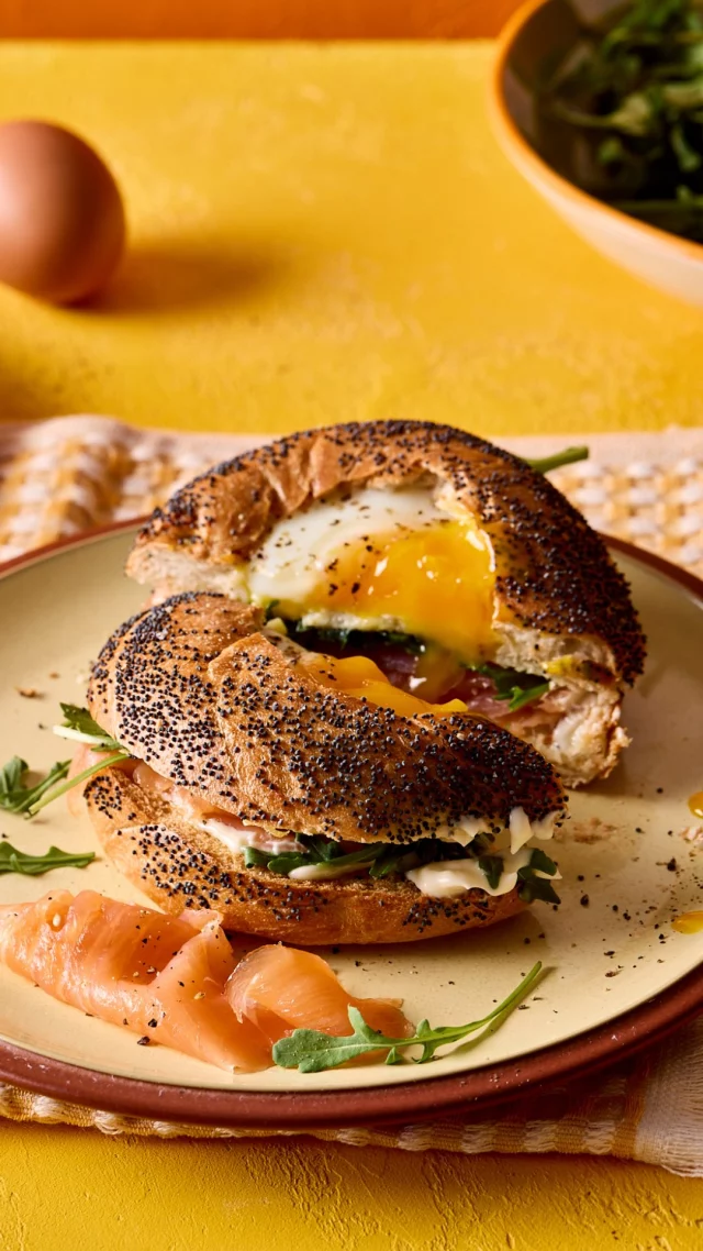 Need the speediest of midweek dinners? 🥚
Baking your FREE egg in the hole of the bagel is just the start of this eggcellent recipe. Stuff your bagel with whatever yummy ingredients you like - we’ve gone for the classic combination of smoked salmon & rocket and ham & mayo - but this speedy lunch can be easily tweaked to include everyone’s favourite fillings.

Ingredients:

FOR THE BAGELS
50g cheese, we used Smoked Applewood
4 bagels
4 FREE free range eggs

FOR THE FILLINGS
Mayonnaise
Ham
Smoked salmon
Rocket leaves

Method:

Preheat the oven to 200C/180C fan/gas 5.

Finely grate the cheese and place four equal piles of cheese on the lined baking tray, in circles the diameter of your bagels.

Slice the bagels in half before cutting a slightly larger hole in the top halves to encase the eggs. Place the top halves of the bagels on the cheese pile and press to ensure the bagels have stuck to the cheese.

Carefully crack an egg in the well of the bagel tops and place in the oven, along with the bagel bottoms, to bake for 6 - 7 minutes, just until the egg has set but the yolk is still runny.
Remove the bagels from the oven and allow to sit for 1 minute whilst you prepare the fillings. We love mayo, ham and leaves as well as mayo, smoked salmon and rocket.

Layer the fillings onto the bottom halves of the bagels. Using a fish slice, carefully remove the top bagels from the baking paper and gently place on top.
Slice and enjoy!